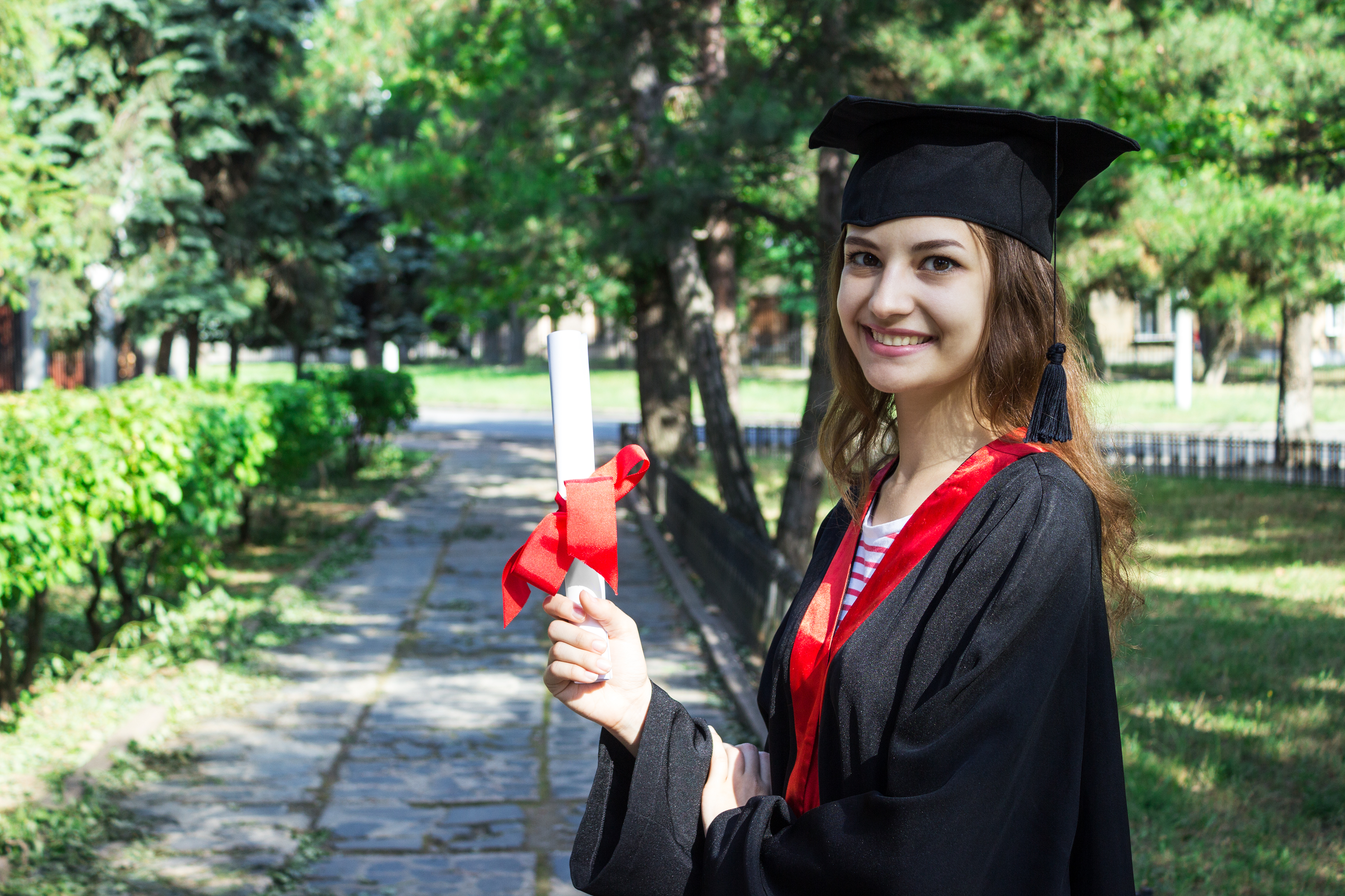 Certified career counsellor holding diploma in a park setting