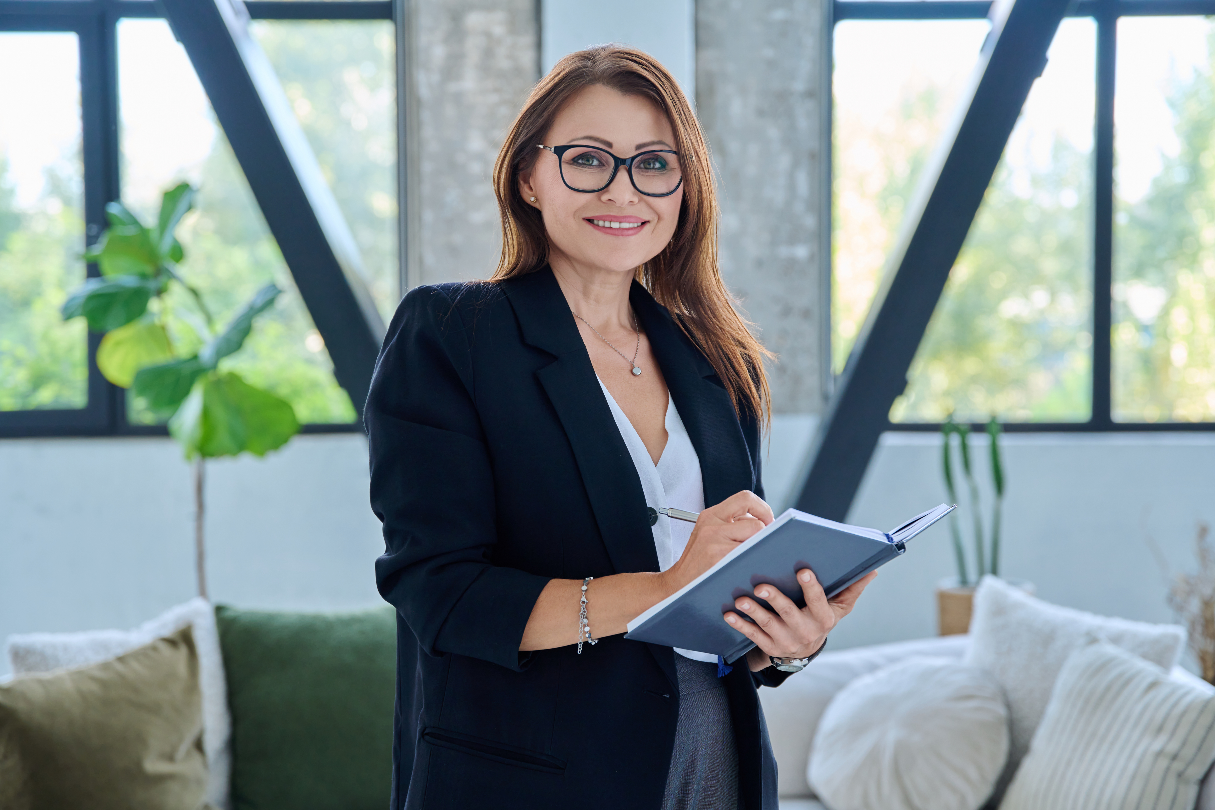 Professional career services provider with notebook in modern office